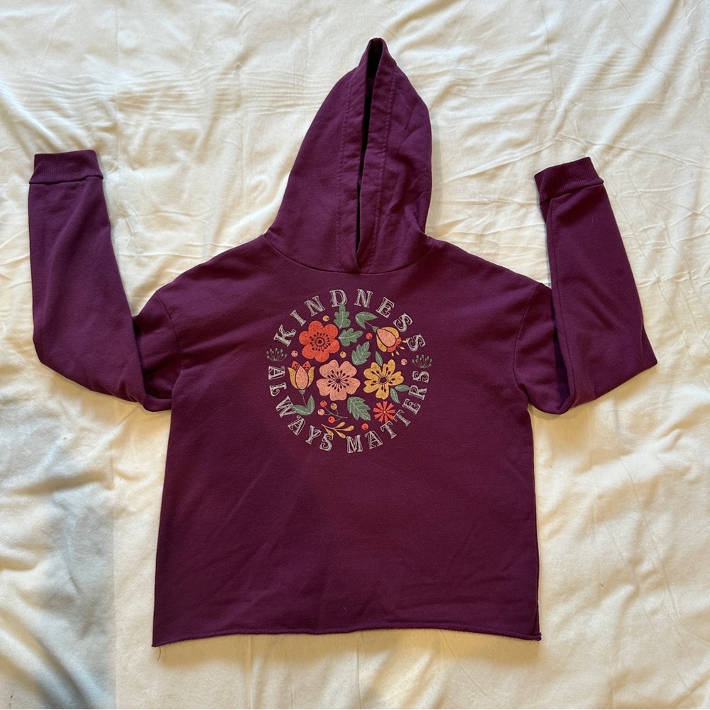 Burgundy and multi-coloured floral hoodie with "Kindness always matters" design.